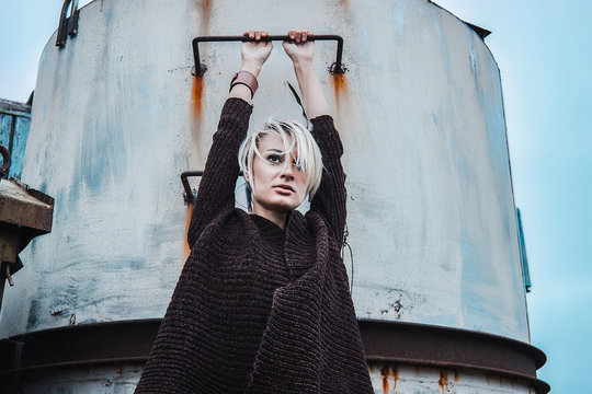 Woman with arms raised holding silo, Odessa, Odeska Oblast, Ukraine, Europe