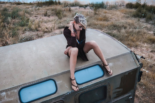 Woman sitting on top of truck looking down, Odessa, Odeska Oblast, Ukraine, Europe
