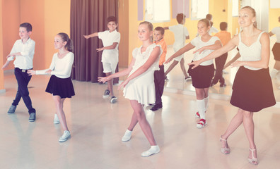 Children learn dance movements in dance class