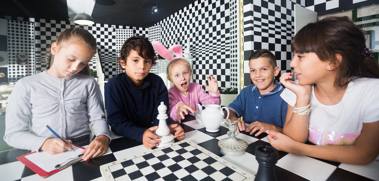 five children play in quest room in chess style