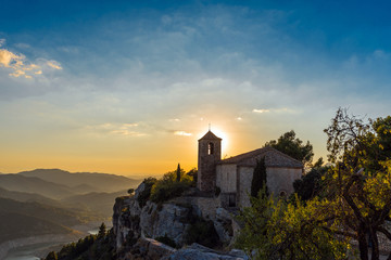 View of the Romanesque church of Santa Maria de Siurana at sunset in Siurana de Prades, Tarragona,...