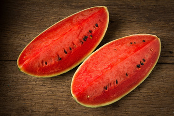 Fototapeta na wymiar slice of ripe watermelon on old wood