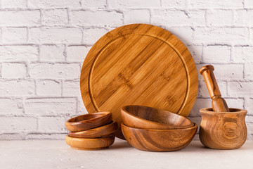 Wooden tableware on a white table.