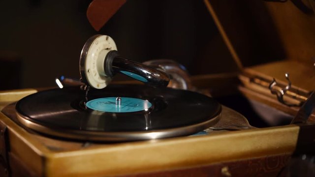 Old gramophone is playing a black shellac record. A rare vintage phonograph records are saved, exclusive and rarity.