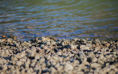 Contact surface of the gravel lot at the shore of the river, wit
