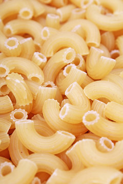 Fusilli dry pasta background concept. Pasta texture for background uses. Swirled pasta pattern. Food photography in studio. Raw pasta.