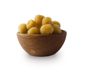 Raspberries in a wooden bowl. Yellow raspberries isolated on white. Vegetarian or healthy eating. Juicy and delicious yellow raspberry with copy space for text. Berry on a white background