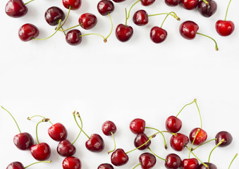 Obraz na płótnie Canvas Ripe cherry on a white background. Cherries at border of image with copy space for text. Top view. Background berries.