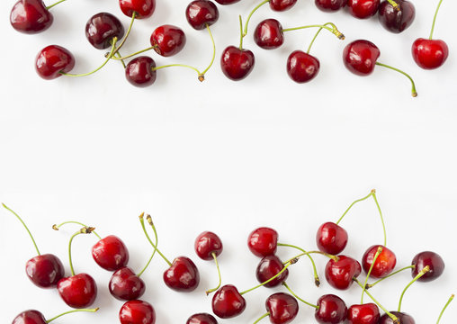 Ripe cherry on a white background. Cherries at border of image with copy space for text. Top view. Background berries.