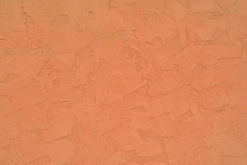 Decorative orange dark stucco wall.
