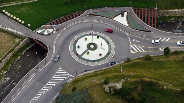 Daytime traffic scene, roundabout of  a highway with the rapid passage of vehicles in Andorra. Time Lapse.  Fixed plane. Logos, etc. are manually blurred.