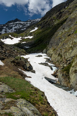 The melting glacier and snow of the mountain peaks in the European Alps during spring