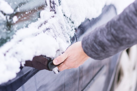 Man unlocking frozen car lock. © AlemTMA