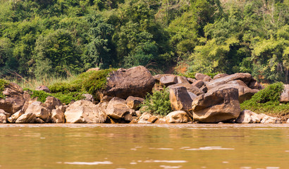 View of the stony bank of the river Nam Khan, Louangphabang, Laos. Copy space for text.