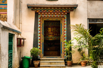 Fototapeta na wymiar entrance hall with nepalese decoration door in hinduist temple in kathmandu. nepal
