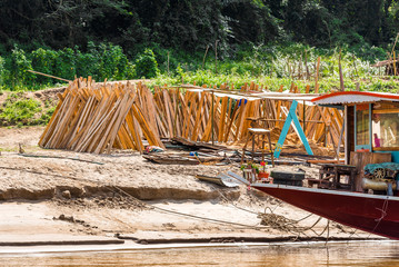 Wooden boards on the bank of the river Nam Khan in Louangphabang, Laos. Copy space for text.