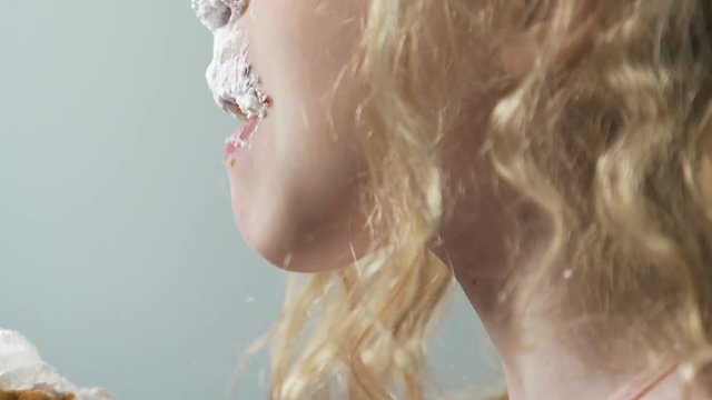 Child eating high-caloried cream cake with mess, dangerous sweet sugary junkfood
