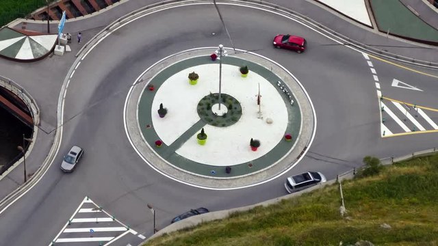 Traffic scene, roundabout of a highway with the rapid passage of vehicles in Andorra.Time Lapse.5 seconds fixed plane + 7 seconds smooth camera movement:zoom out.Logos, etc.are manually blurred.