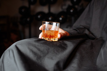 man hold a glass of whiskey 