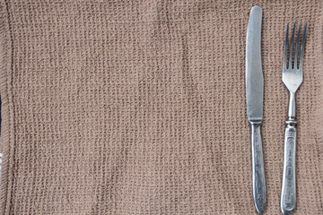 The knife and fork is located on the towel and a place for recording.