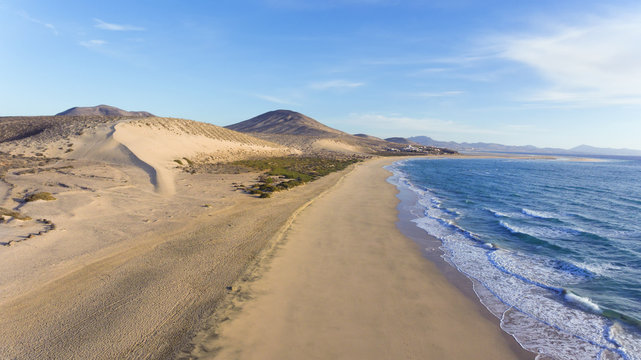 Aerial view of white sand beach, dunes, mountain panorama, Jandia, Costa Calma, Fuerteventura, Canary Islands .