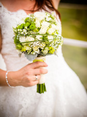 the bride is holding the bridal bouquet