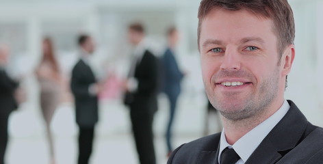 Happy mature business man looking at camera with satisfaction at office