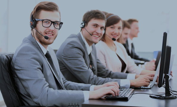 experienced assistants with a headset in front of computers in t