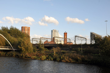 Fototapeta premium the river aire in leeds taken from the footpath showing the south bank and holbeck with the railway tracks in between