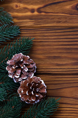 Christmas decoration cones fir on brown wooden background.