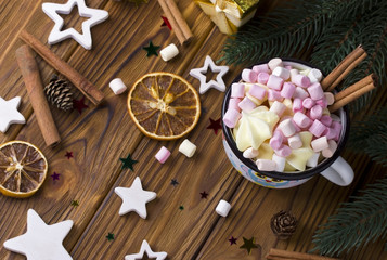 Christmas background star, cup marshmellow cinnamon brown wooden table.