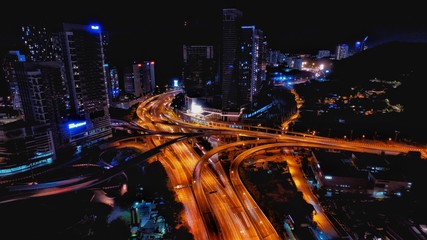 Aerial photography of urban city highway with traffic's light trail at night.
