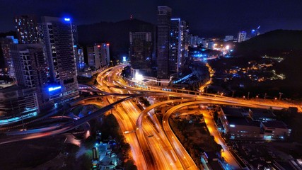 Aerial photography of urban city highway with traffic's light trail at night.