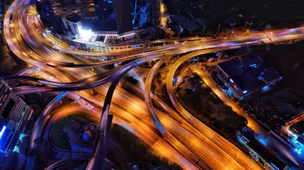 Aerial photography of urban city highway with traffic's light trail at night.