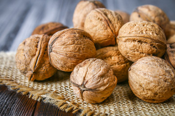 Shell and walnut bones on a brown wooden table.