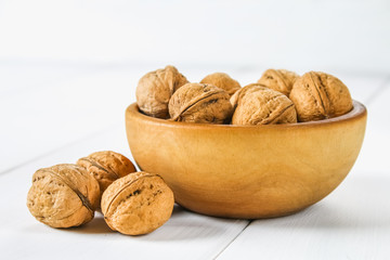 Shells and bones of walnut on a white wooden table.