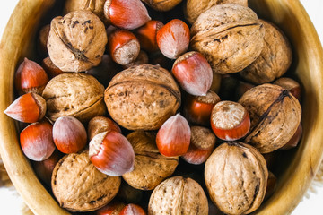 Shells and bones of walnut on a white wooden table.