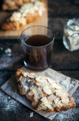 Fresh baked croissant with almonds slices served with coffee,selective focus
