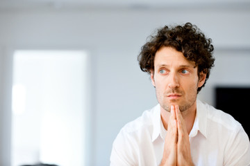 Portrait of a smart young man standing in kitchen