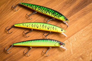 Set wobblers on wooden background. Fishing lures.