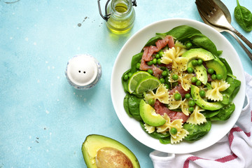 Pasta salad with spinach,avocado,salted salmon and green pea.Top view.