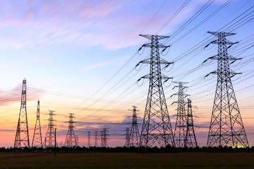 High voltage power tower landscape at sunset