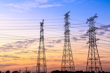 High voltage power tower landscape at sunset