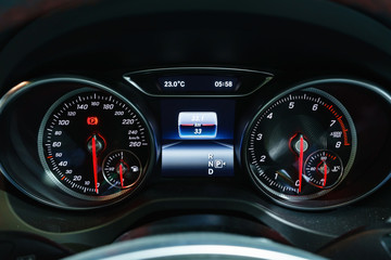 Modern light car mileage (dashboard, milage) isolated on a black background. New display of a modern car. RPM, Fuel indicator and temperature. Fuel economy.