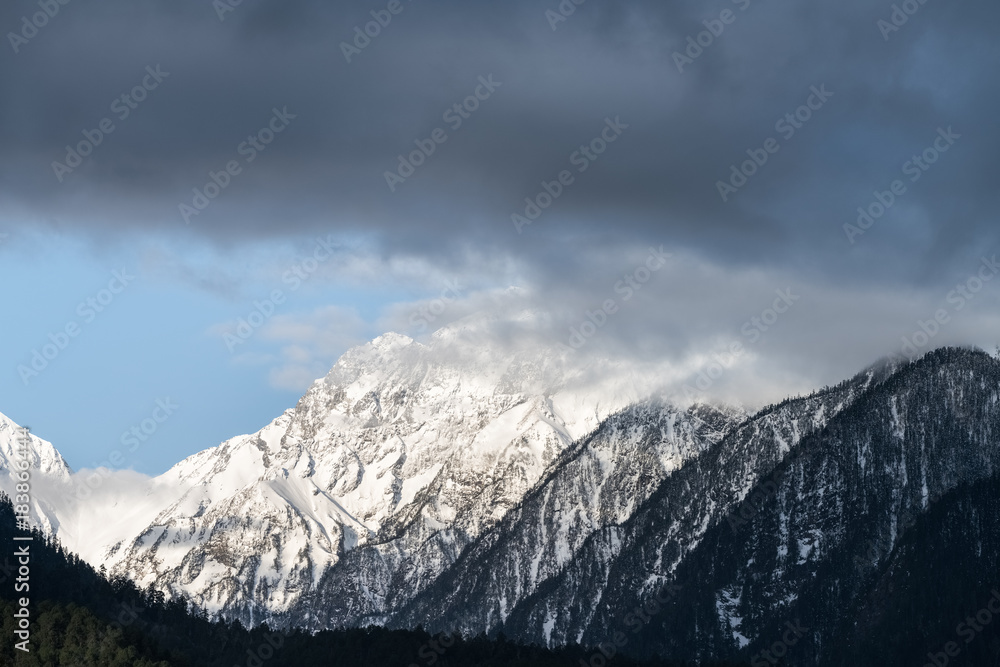 Sticker snow capped mountain and misty clouds