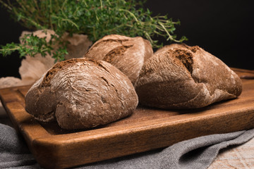 Homemade farm malt bread, malt flour on wooden table