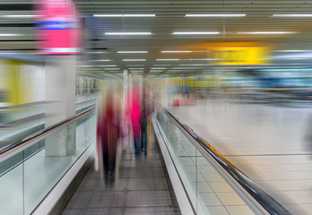 Travelator speed-walk for passengers at the airport with silhouettes of people