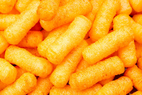 Cheese puff. Cheese puffs snack background texture food pattern. Puffed cheese snack photo.