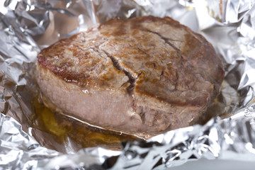 a filet steak cooking in aluminium foil
