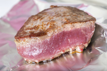 a filet steak cooking in aluminium foil